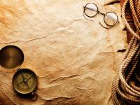 Компас и очки на пергаменте